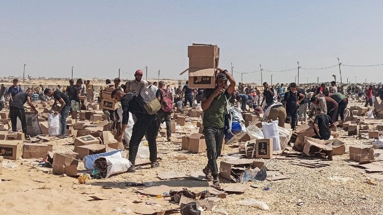 Palestinians gather to collect what remains of relief supplies of the U.S.-backed Gaza Humanitarian Foundation, in Rafah